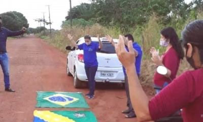 Moradores oram com a bandeira do Brasil e do estado